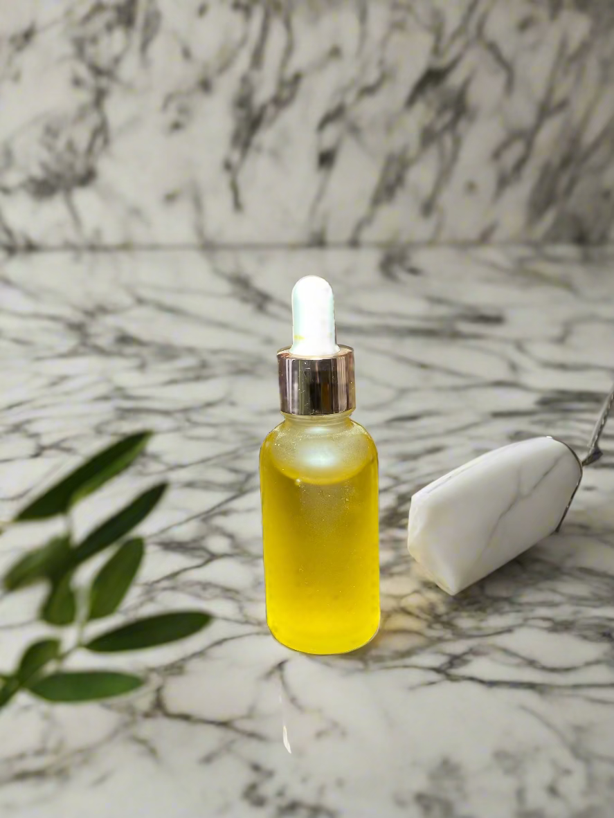 Yellow dropper hair growth oil bottle on marble surface