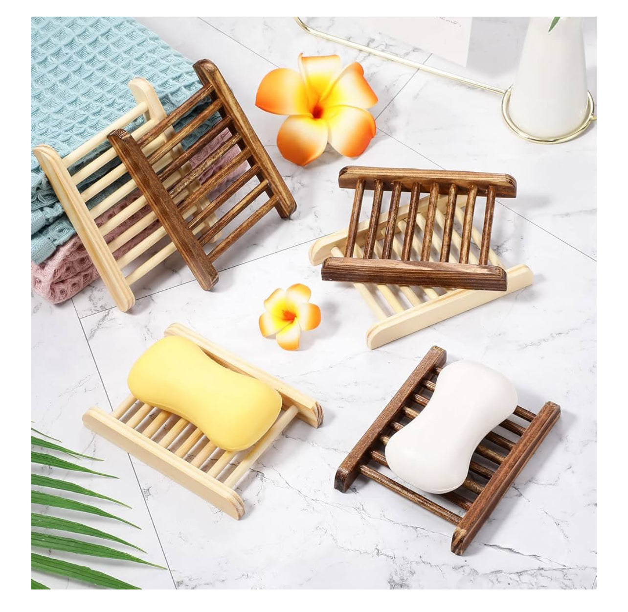 Wooden soap dishes with soap on a light surface